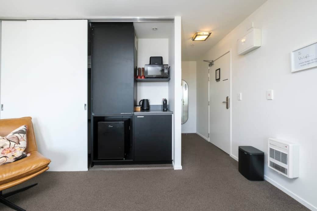 Kitchenette stocked with a Nespresso machine, microwave, toaster, and jug—ideal for a quick bite or morning coffee.