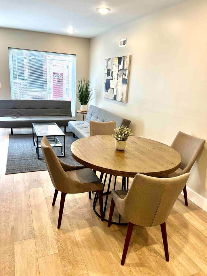 The dining room effortlessly transitions into the living room, creating a harmonious flow between the two spaces. The living area is equipped with a flat-screen TV, perfect for relaxation and the room also features two comfortable futon sofa beds.