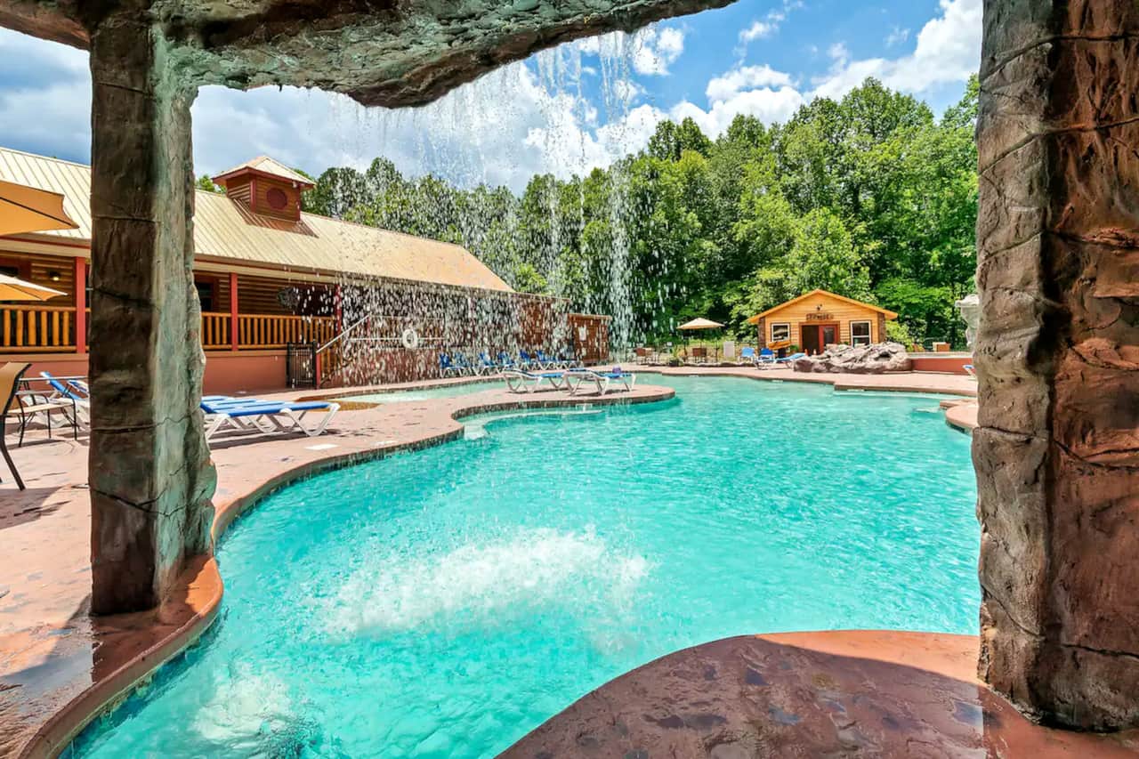 Enjoy the resort-style swimming pool with a beautiful waterfall, surrounded by mountain scenery