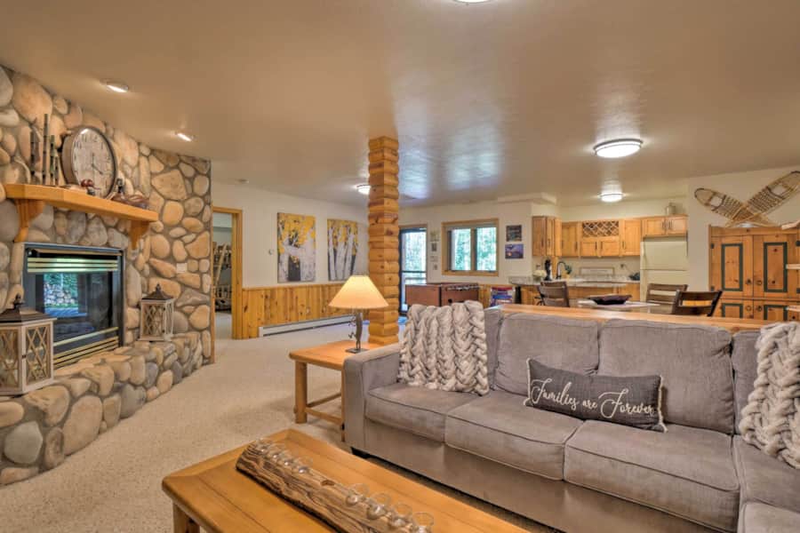 Lower-level family room with gas fireplace, sofa and game area