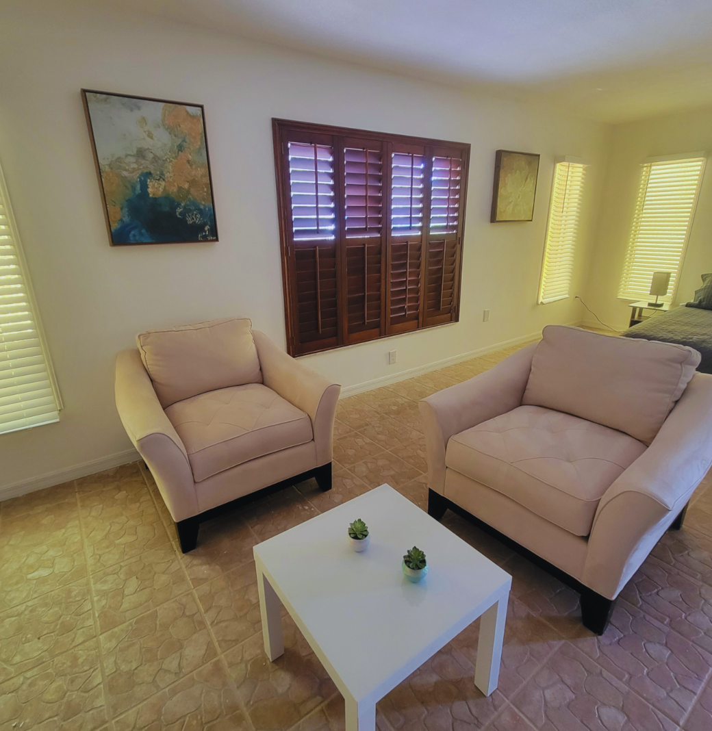Inviting seating area with comfortable chairs, a coffee table, and sunny windows. Lakeland, FL Inviting seating area with comfortable chairs, a coffee table, and sunny windows. Lakeland, FL