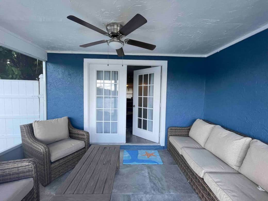 Screened, covered patio and outdoor living space overlooking the serene lake—perfect for relaxing.