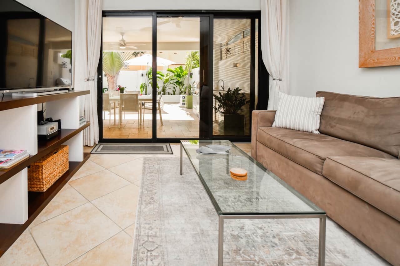 Living room with cable TV and walkout to backyard