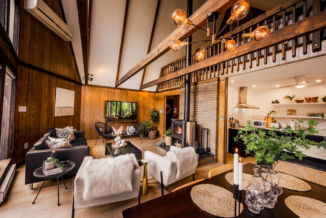 Step into this living room sanctuary, where vaulted ceilings and sunlit windows invite the fresh air