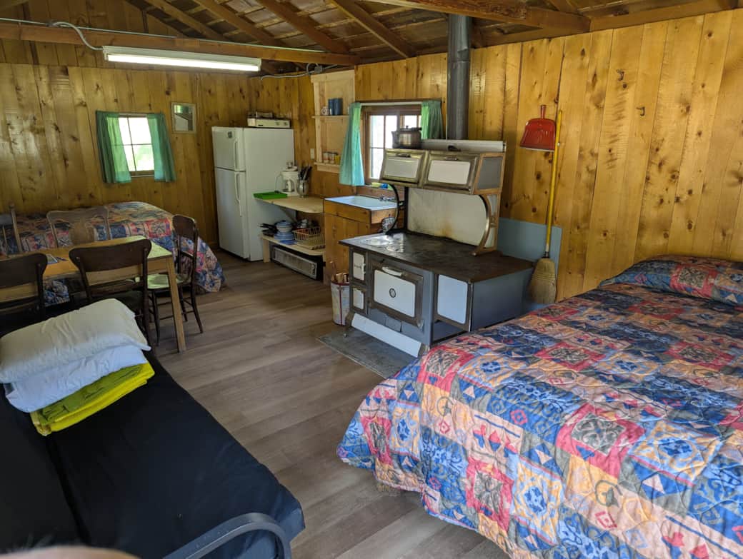 Cabin 3 is a cozy rustic cabin that features a wood-burning stove.