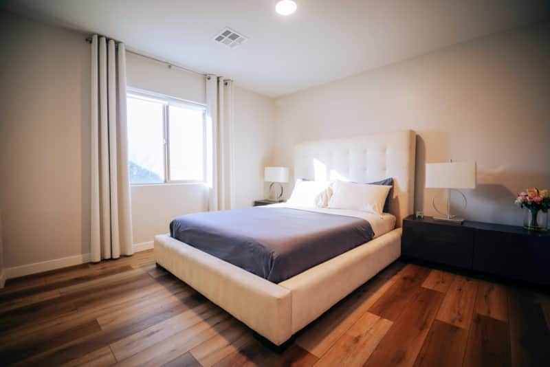 Queen bedroom with an upholstered headboard and bedside storage.