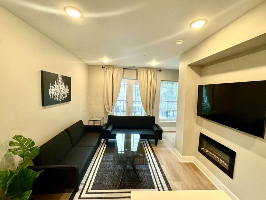 living room with 50 inch TV fireplace two sofa beds and the double door you can walk out to the deck.