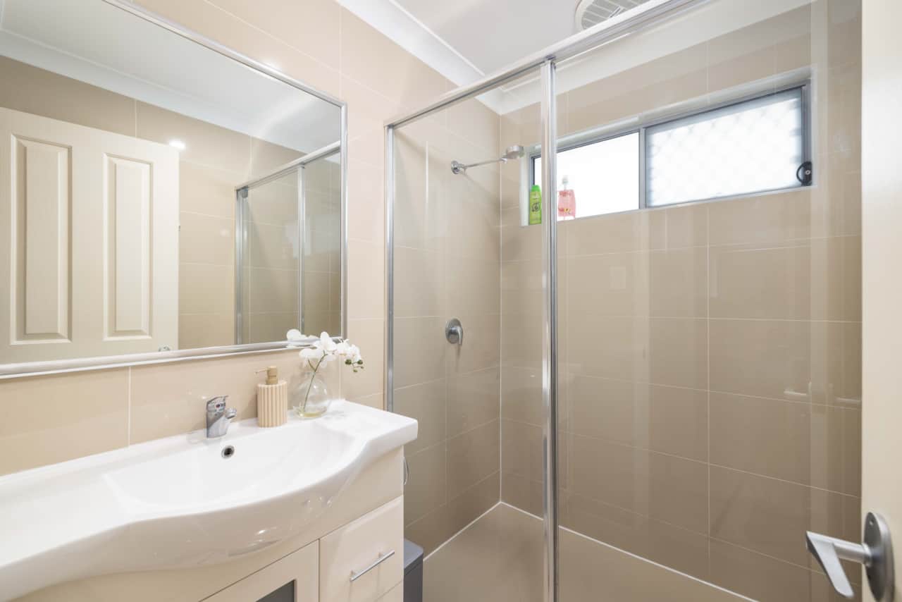 Bathroom: Stylish bathroom with walk-in shower, vanity, and clean finishes