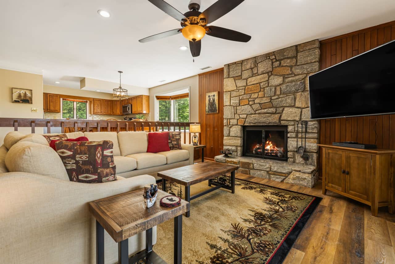 Living room with new gas fireplace, new sectional couch and coffee table, Smart TV and views of Chet