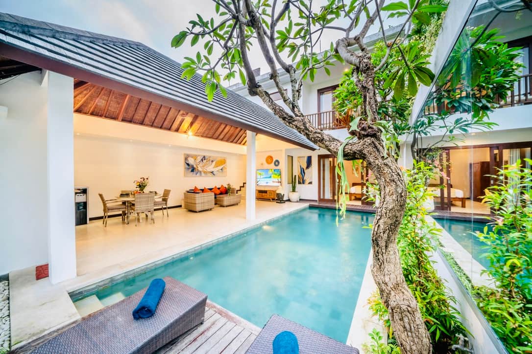 Sparkling pool with relaxing sunbeds and garden views