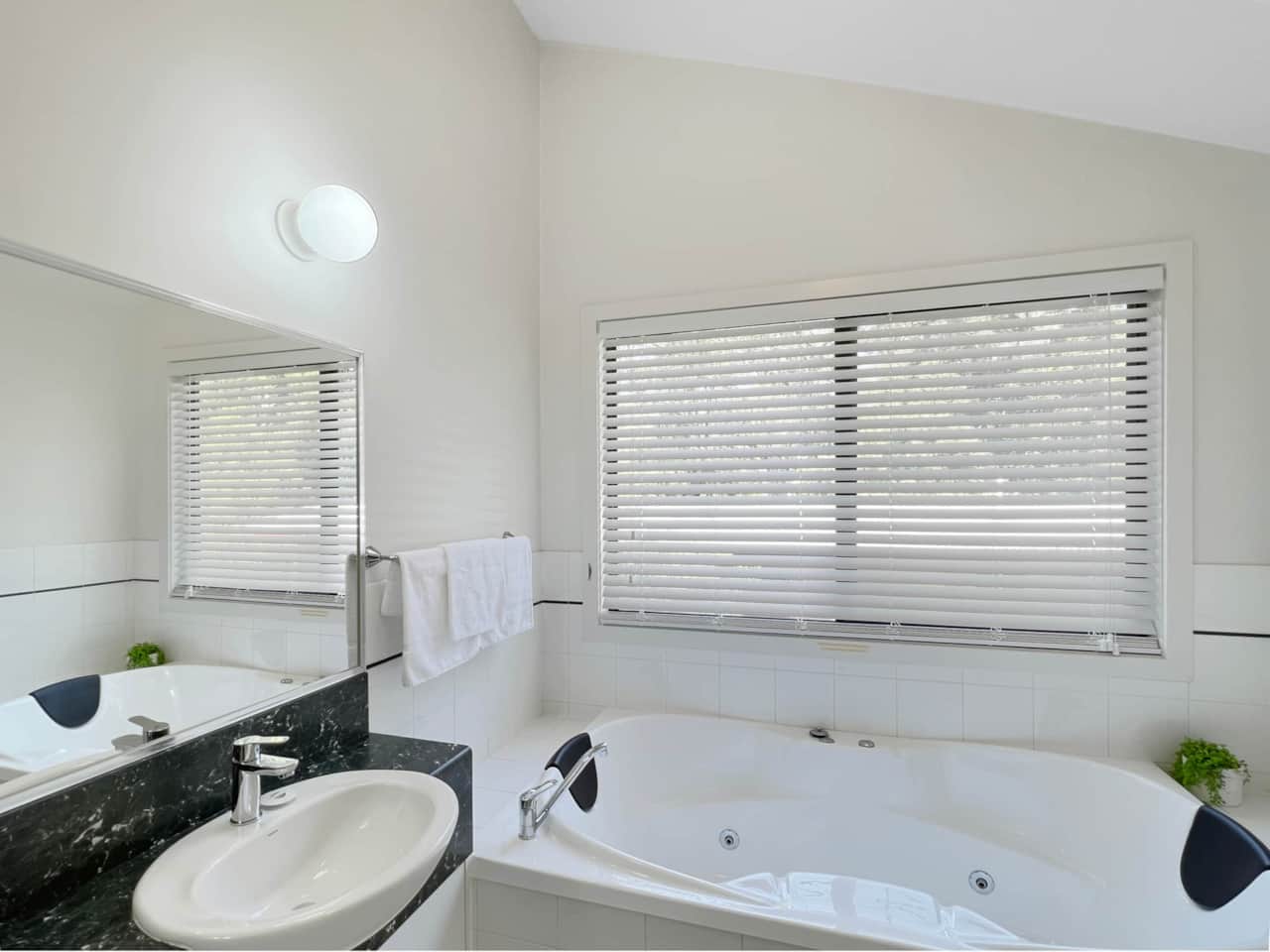 Relax in the upstairs ensuite, a private oasis with a luxurious bathtub.
