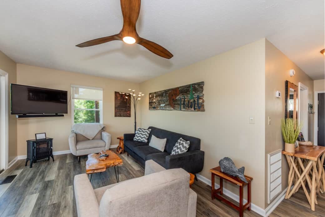 Living room with LG Smart TV for all of your streaming needs. Fiber optic WiFi ensures seamless viewing. Electric pot-belly stove for ambiance and warmth.