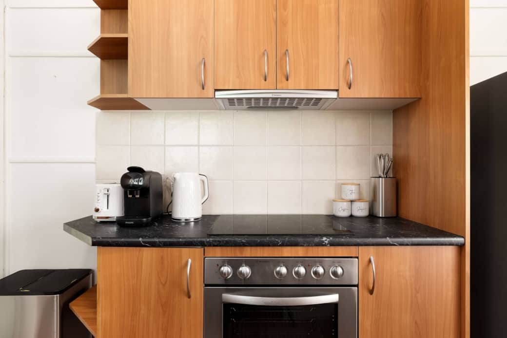 Kitchen: Sleek kitchen with ample storage, modern appliances Kitchen: Sleek kitchen with ample storage, modern appliances