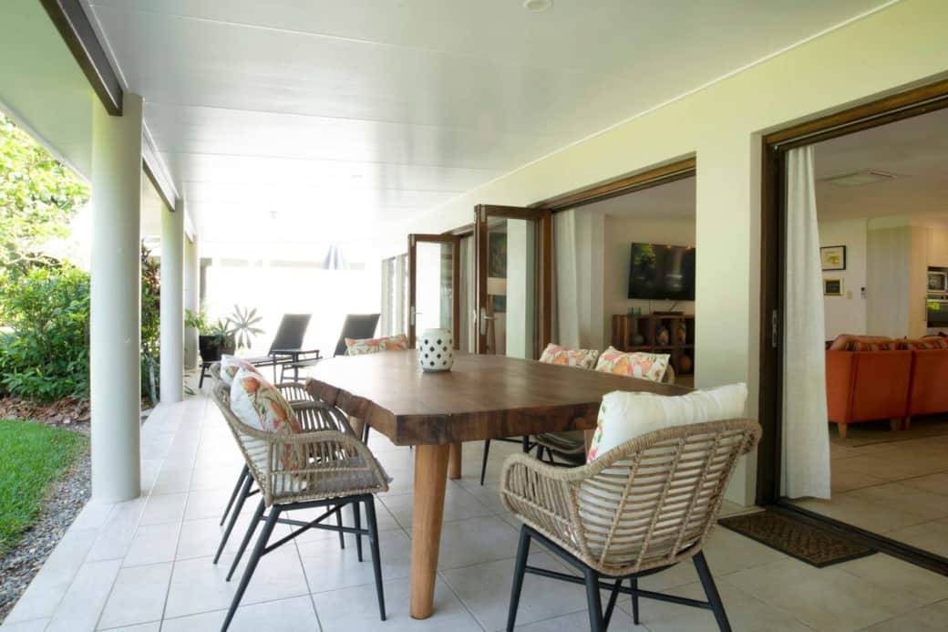 Alani - Beachfront patio with dining table and sun lounges