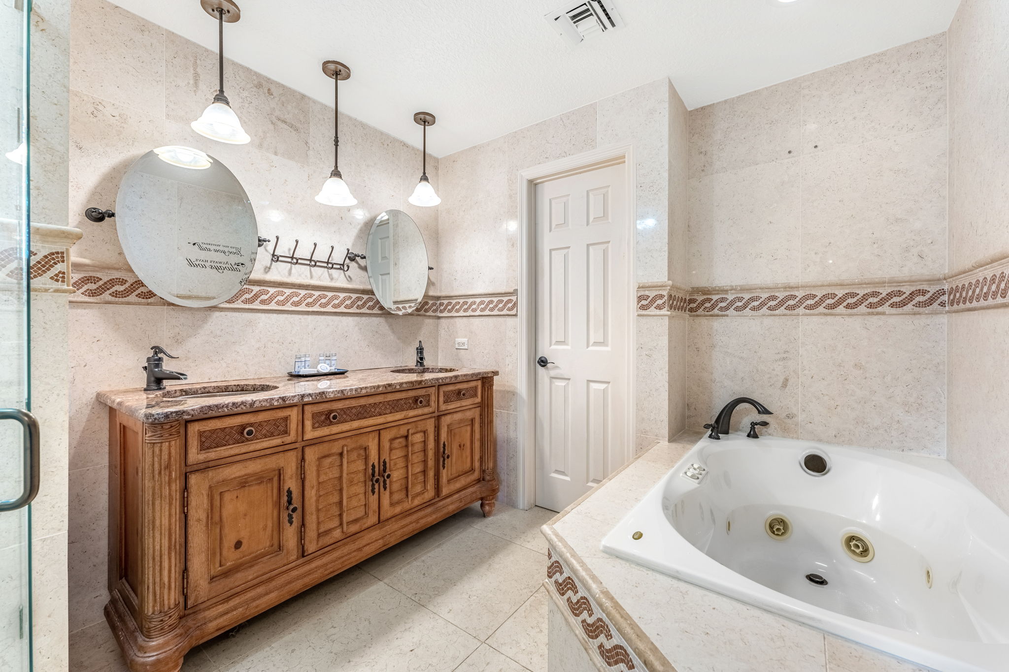Indulge in a spa-like experience at the master bathroom featuring a large soaking tub.
