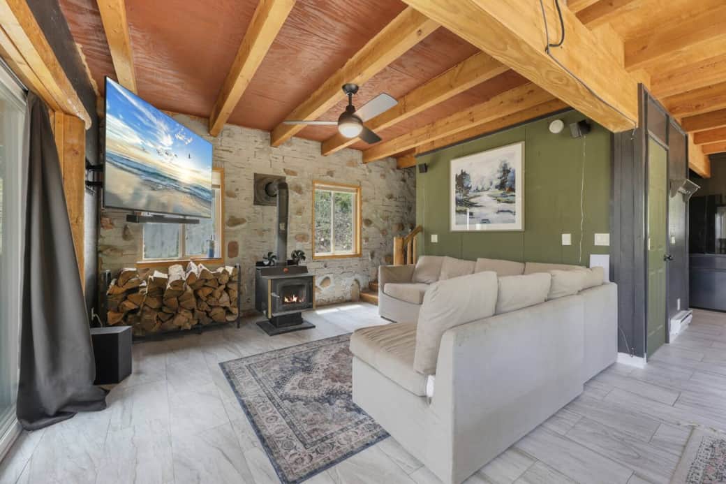 Living room with a tv that swivels for whatever angle you need it at. Surround sound for your movie goers, a comfy couch, and a wood burning fireplace. What else could you ask for in this amazing living room! Living room with a tv that swivels for whatever angle you need it at. Surround sound for your movie goers, a comfy couch, and a wood burning fireplace. What else could you ask for in this amazing living room!