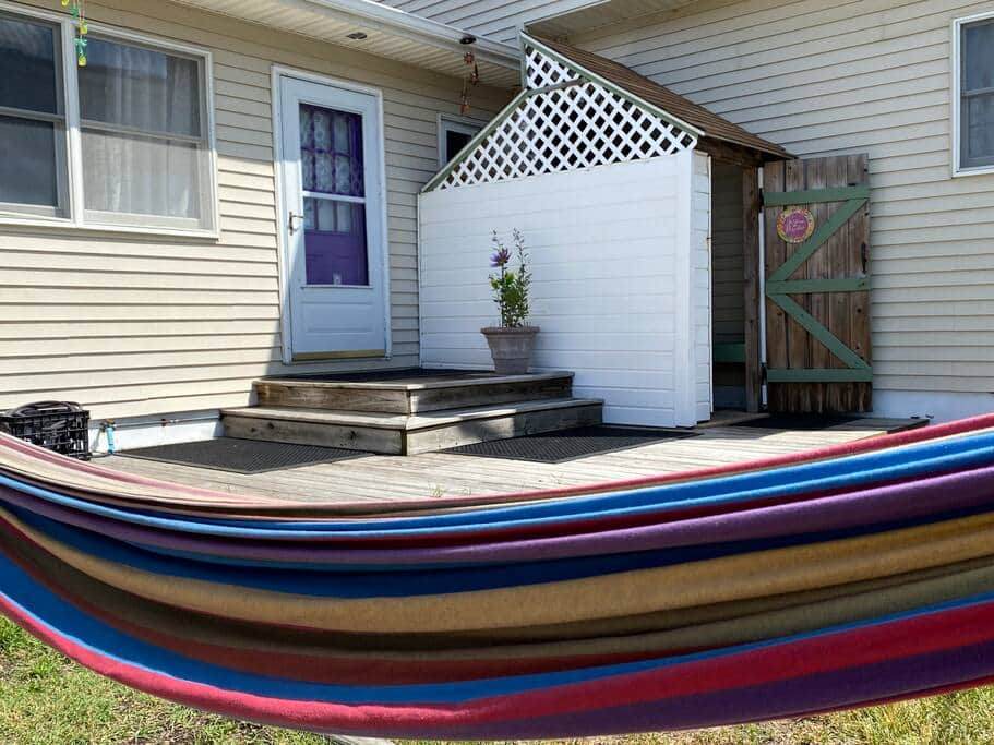 Backyard area with a hammock for soaking up the sun and the much loved outdoor shower.