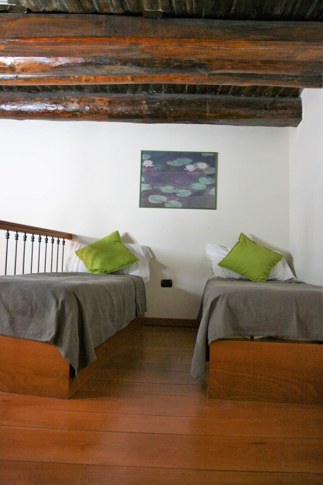Two single beds on the mezzanine of the living room