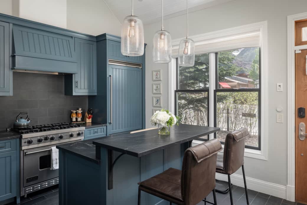 Fully stocked and comfortable kitchen with additional seating