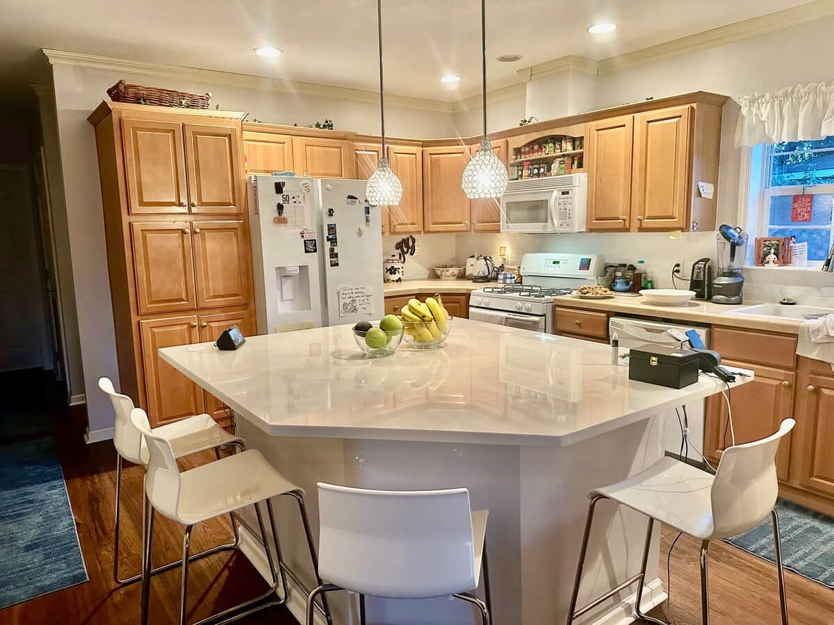 There is seating for four at the kitchen counter. Equipped with pots, pans, mixing bowls, utensils.