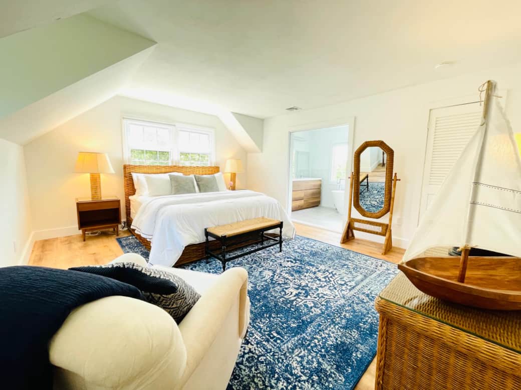 The Treetop Suite, aka the primary suite, with double doors that lead to the ensuite bath
