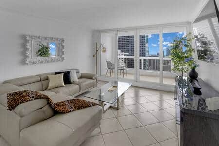 Living area with 65" Roku streaming tv, balcony access