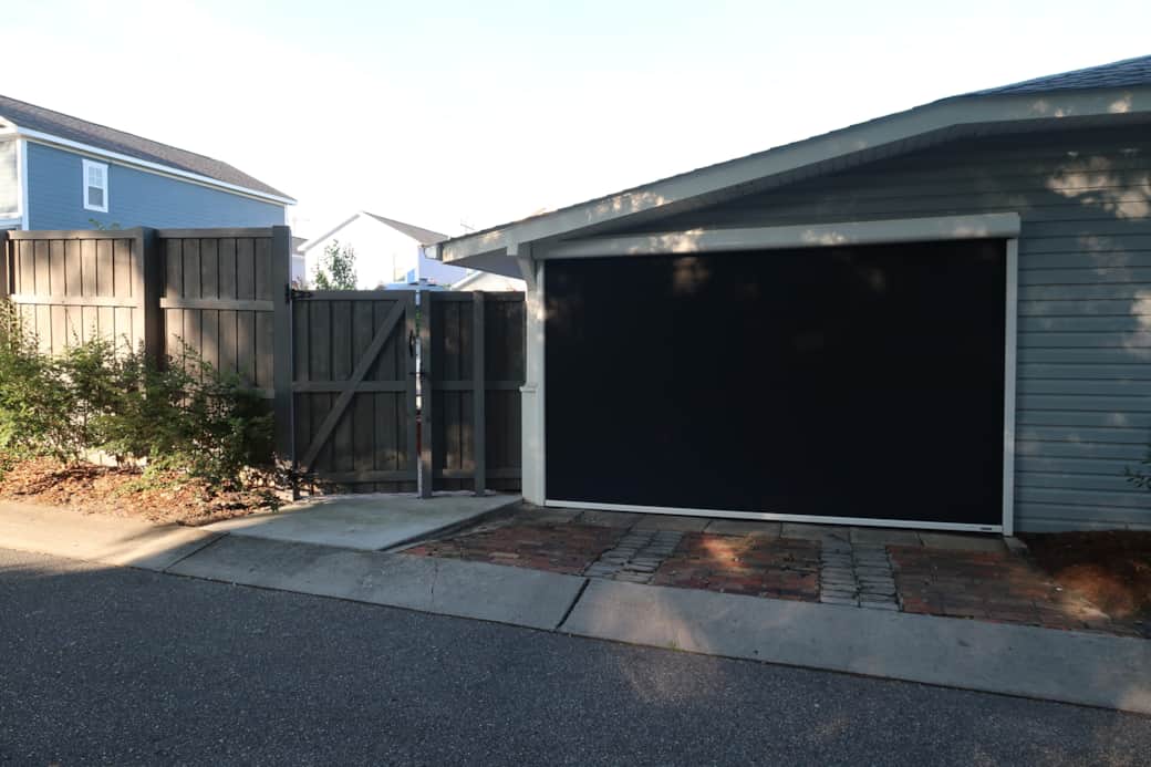 Motorized Privacy Screen that encloses the carport and backyard to a private retreat. 