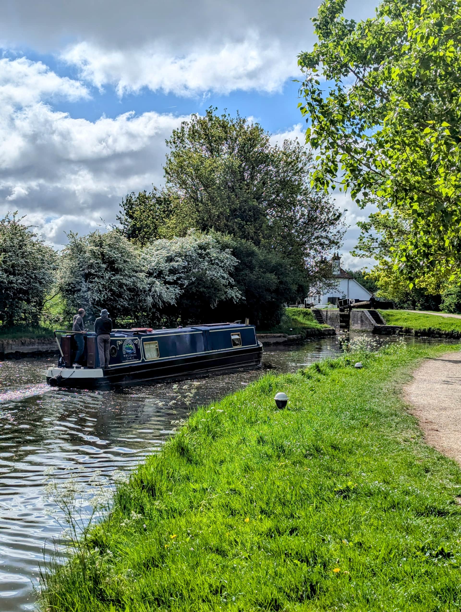 Family narrowboat cruising through the Chilterns at Marsworth