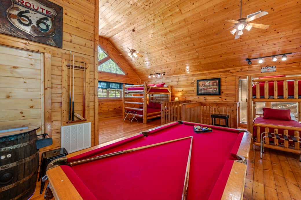 Rack ’em up in the loft’s game zone—pool table front and center with cozy queen & twin bunks