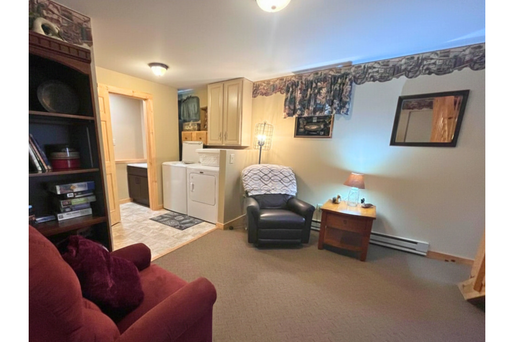 Lower Level Lounge space with laundry and 1/2 bath. 