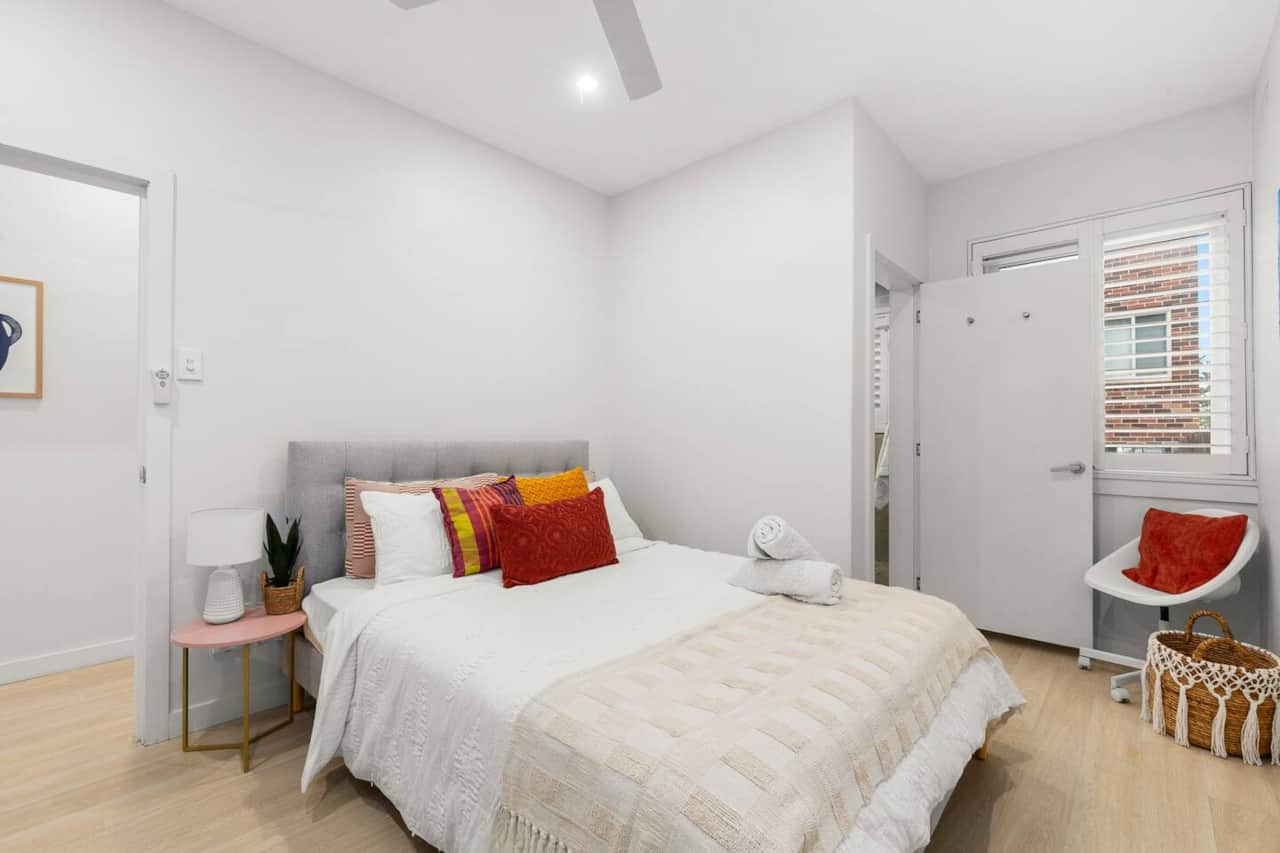 Master bedroom queen bed closet & storage
Master bedroom with white linens in modern Bondi apartment