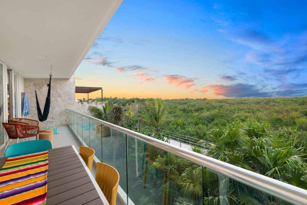 Spacious private balcony with outdoor chairs—perfect for coffee or a drink overlooking the Akumal jungle. Also features a dining table for 6 and a relaxing hammock to unwind and enjoy the view.