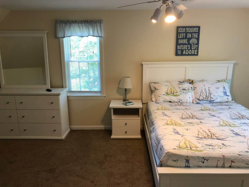 Spacious second-floor bedroom with a cozy queen bed, natural light, and a TV, perfect for restful evenings on your Cape Cod getaway Spacious second-floor bedroom with a cozy queen bed, natural light, and a TV, perfect for restful evenings on your Cape Cod getaway