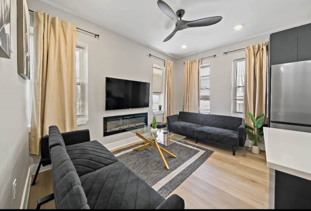 Welcome to our stylish modern living room! Enjoy two cozy sofa beds, a fireplace, and a large flat-screen TV with Ruko, Apple TV, and Netflix. Stay connected with complimentary WiFi and relax with Boardwalk and ocean views.