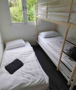 The pull- out bed makes space for 3 to share.  This bedroom has views over the woodlands.