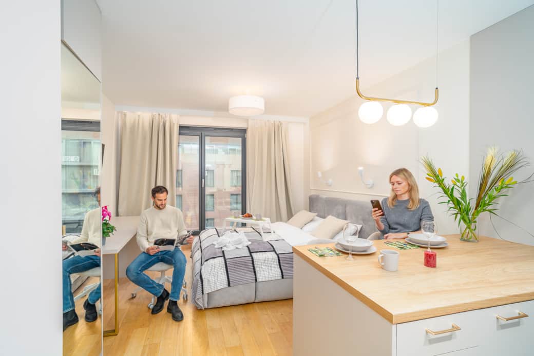 A modern, bright studio with a sleeping area and a kitchenette.