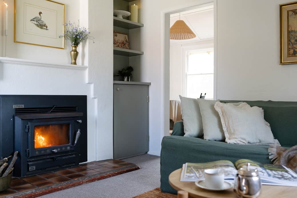Apartment A lounge room offers slow combustion fireplace, TV and portable Bluetooth speaker 