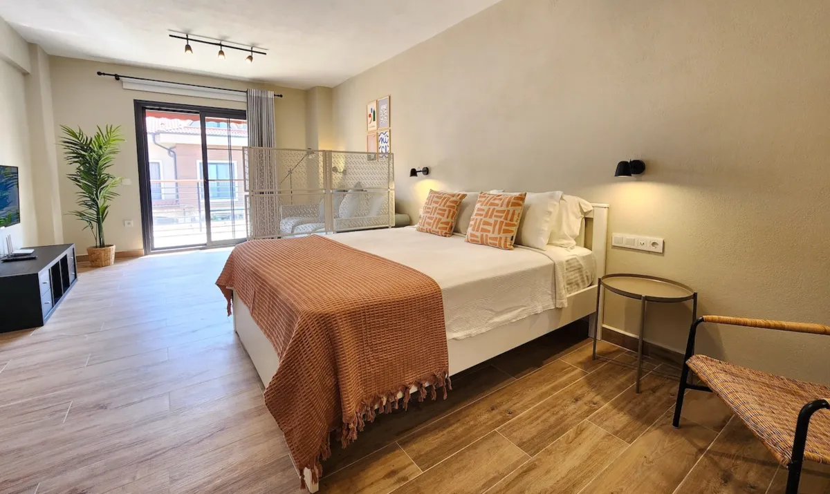 Bedroom with a double bed, decorative pillows, and a chair, Apart Guney 8, Gocek.