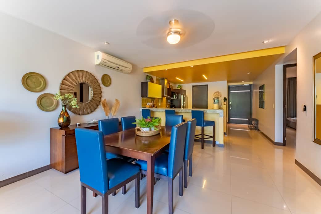 Open concept living room and dining room with a large kitchen table that comfortably seats six