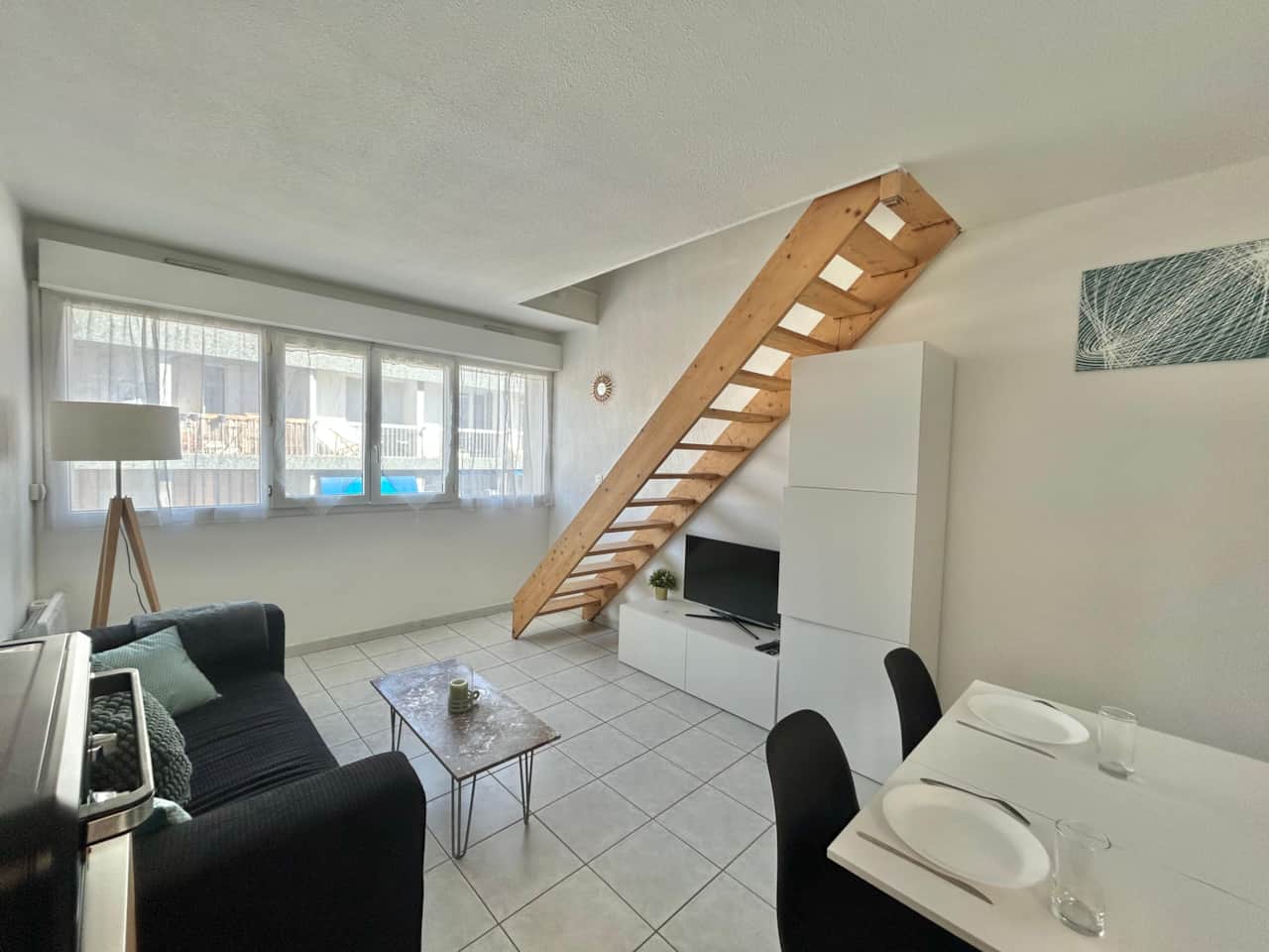 Living room, sofa, dining table, chairs, lamp, coffee table, TV, stairs