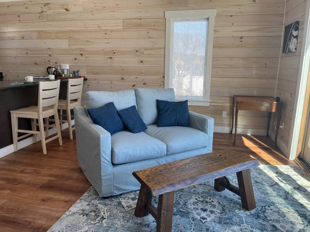 Light-filled space! Comfy sofa, wood details, & warm feel. Perfect for unwinding.