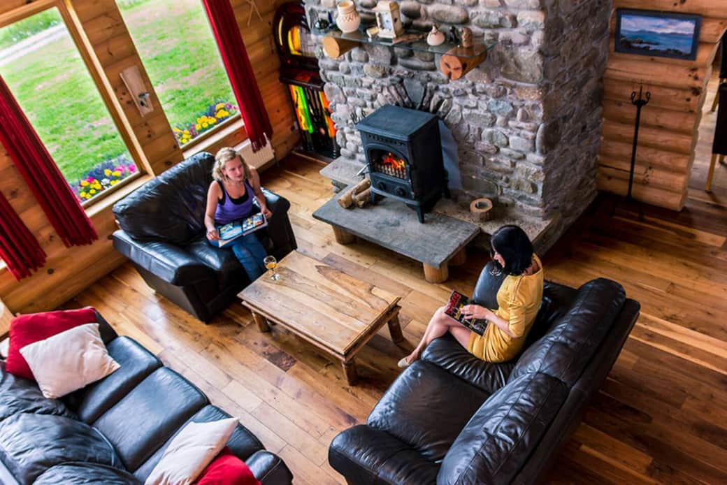 Living room with river rock fireplace looking down from balcony Living room with river rock fireplace looking down from balcony