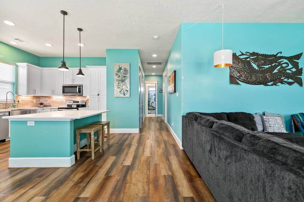 Entryway showing kitchen and island to left and Living room to right