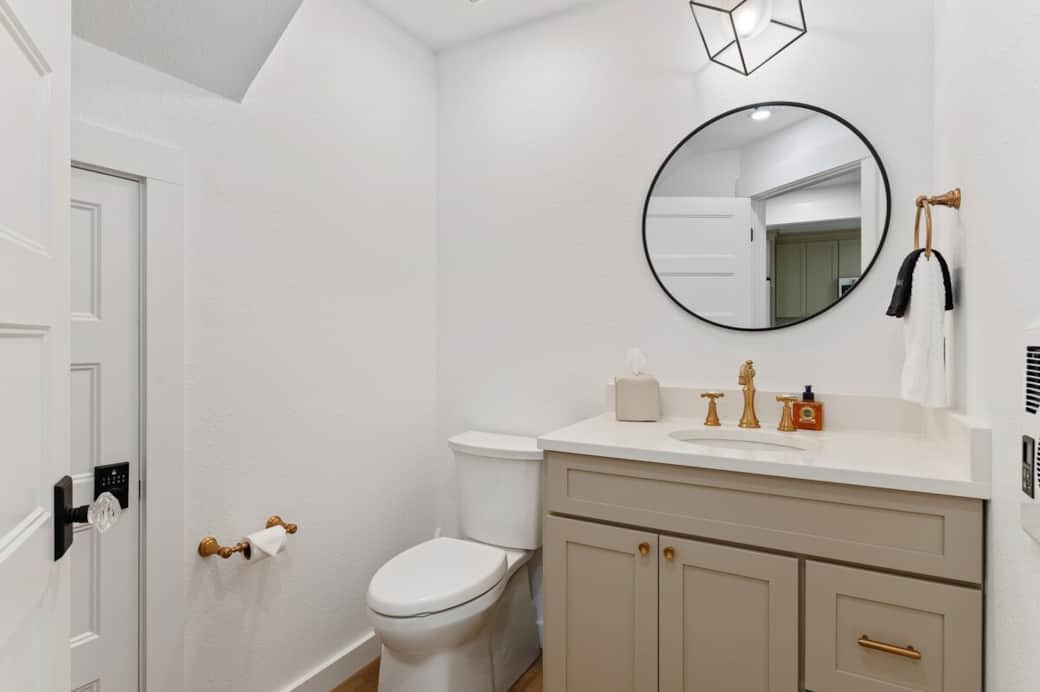 This 1/2 bathroom is downstairs. There is a First-Aid wall station.  An extra hair dryer is in the drawer. You'll find the hamper for all your bath towels here, too.