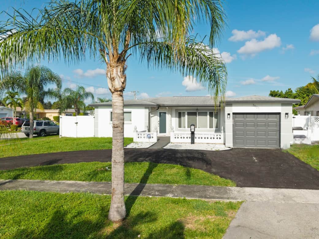 Charming single-level home with inviting curb appeal, framed by palm trees and a spacious driveway. A welcoming first impression that sets the tone for a relaxed, comfortable stay.