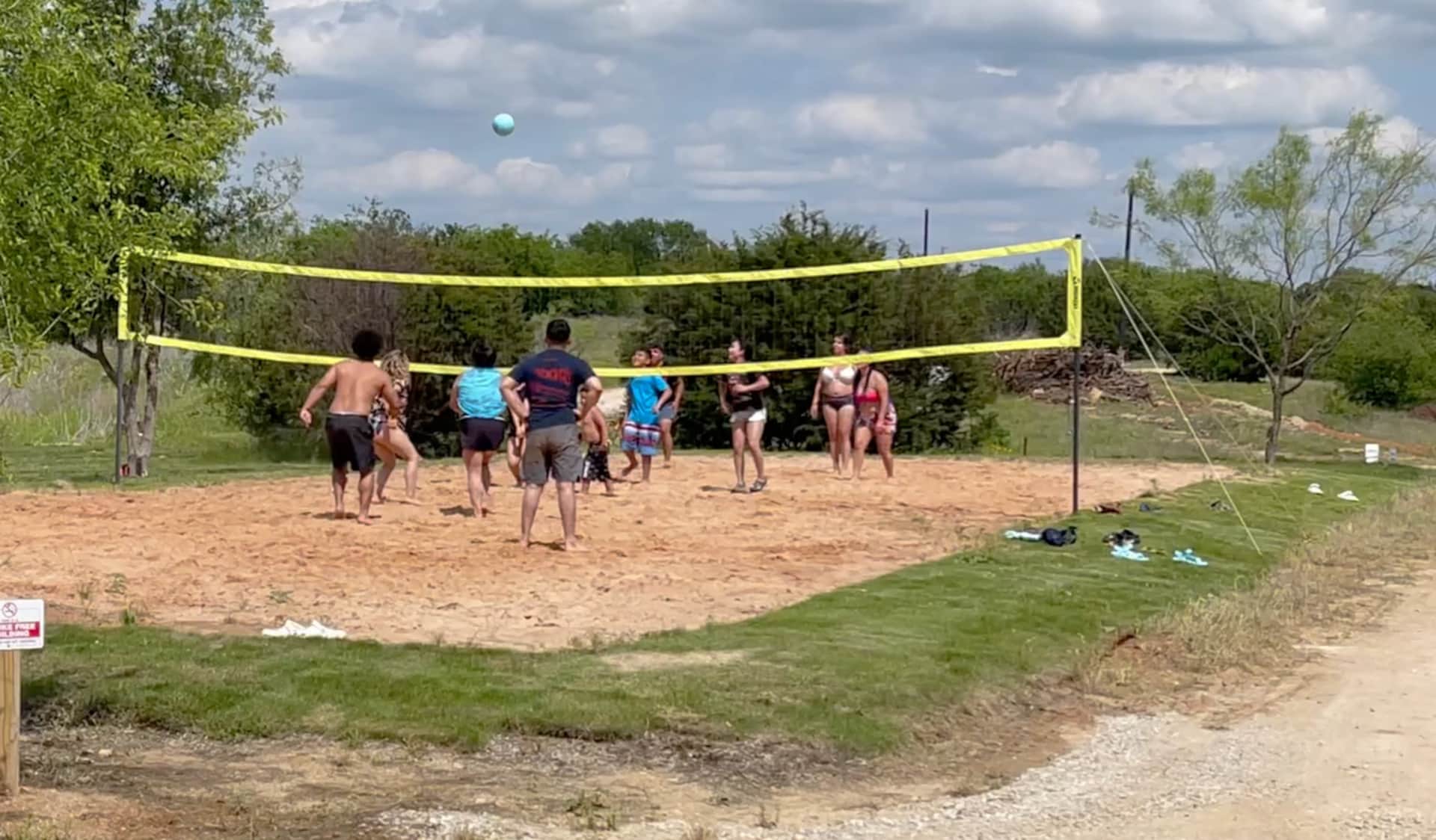 Church family playing sand volleyball at the sports fields Lake Godstone Graford Texas