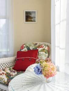 The sunroom is a beautiful spot for relaxation  with your morning coffee.