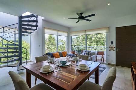 Elegant dining for four: Table, dinnerware, wine glasses.