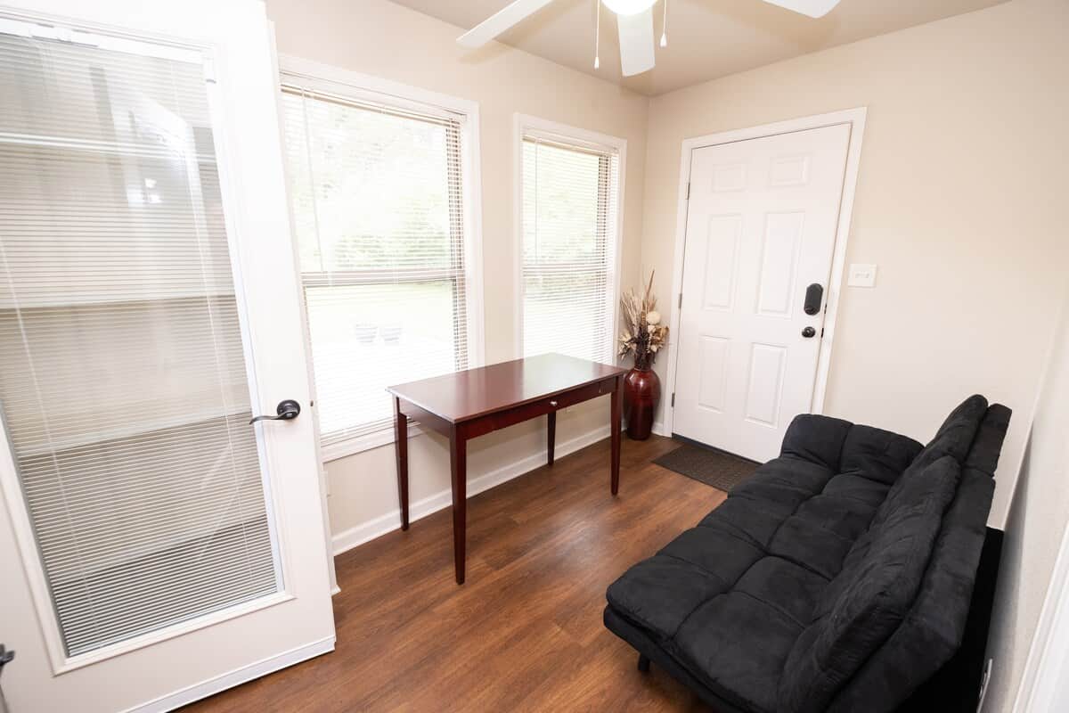 Office with comfortable Futon with Memory Foam mattress and adjustable headrest provide sitting or sleeping space.  Behind the door is floor to ceiling built-in bookcase. 