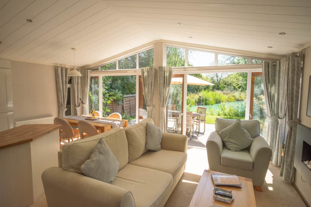 The view from the living area with the two sets of double doors open onto the patio and garden area.
